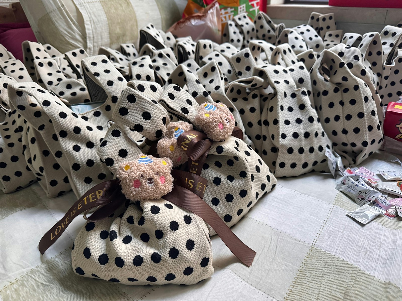 Many polka dot gift bags with teddy bear decorations