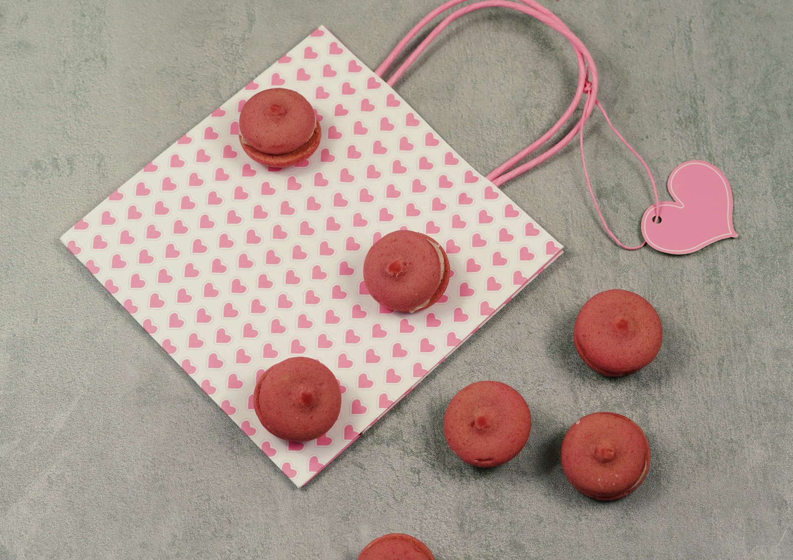 a table topped with macaroons and a pink heart